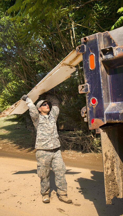 Air Force Tech. Sgt. Brian Grim throws debris onto a truck in Clendenin, W.Va., June 26, 2016, while assisting with flood response efforts. Grim is assigned to the West Virginia Air National Guard’s 167th Airlift Wing. Air National Guard photo by Tech. Sgt. De-Juan Haley