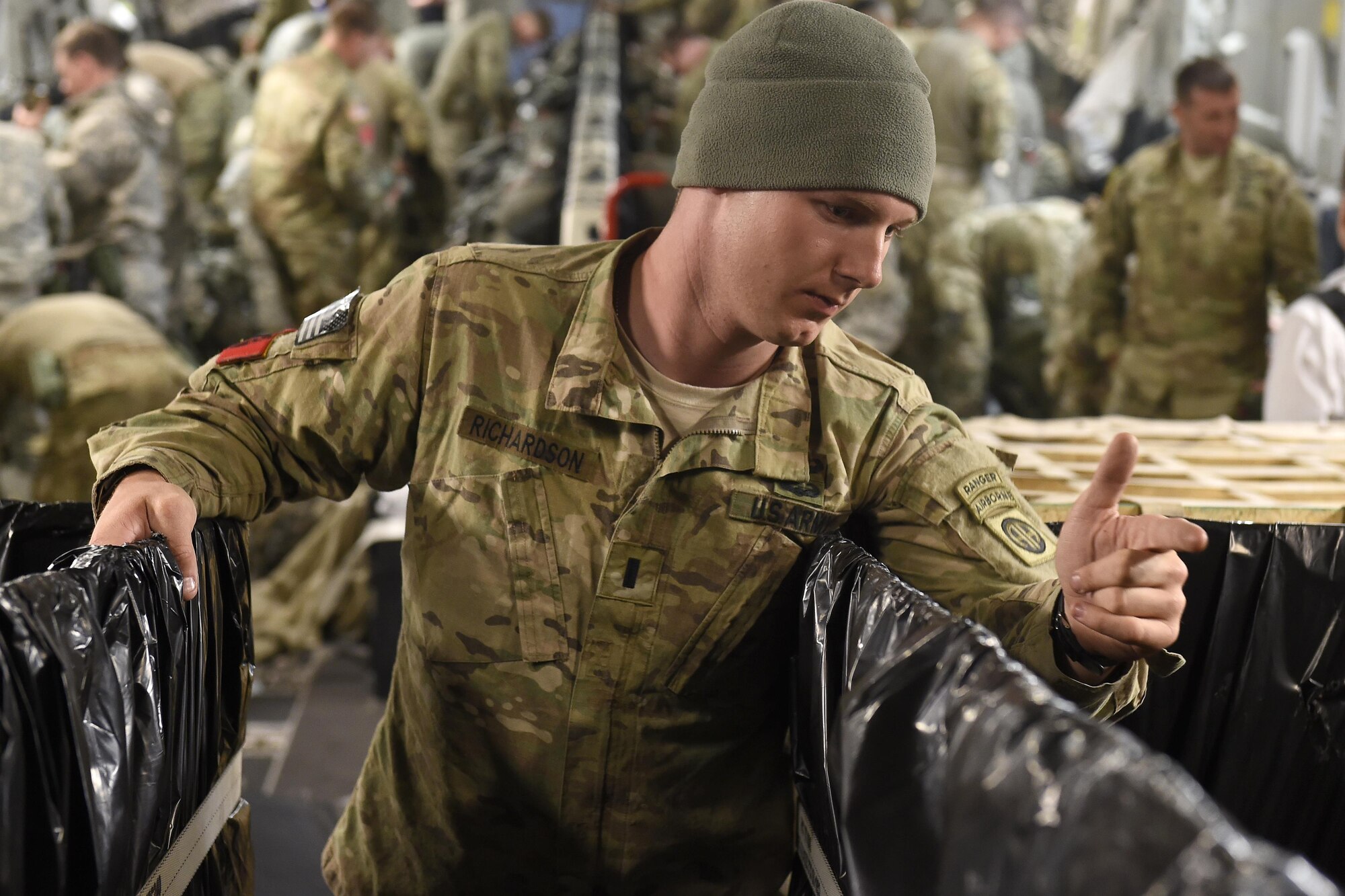1st Lt. Michael Richardson, 82nd Airborne Division, Fort. Bragg, N.C., helps distribute parachutes to paratroopers for a static-line jump into Gabon, Africa June 20, 2016, in support of exercise Central Accord 2016. U.S. Army Africa's exercise Central Accord 2016 is an annual, combined, joint military exercise that brings together partner nations to practice and demonstrate proficiency in conducting peacekeeping operation. (U.S. Air Force photo/Tech. Sgt. Tim Chacon)