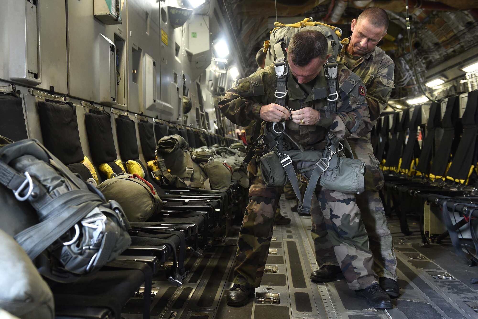 French paratroopers prepare for a static-line jump out of a 62nd Airlift Wing C-17 Globemaster III, stationed out of Joint Base Lewis-McChord, Wash., June 22, 2016 near Libreville, Gabon Africa during exercise Central Accord 2016. U.S. Army Africa's exercise Central Accord 2016 is an annual, combined, joint military exercise that brings together partner nations to practice and demonstrate proficiency in conducting peacekeeping operation. (U.S. Air Force photo/Tech. Sgt. Tim Chacon)