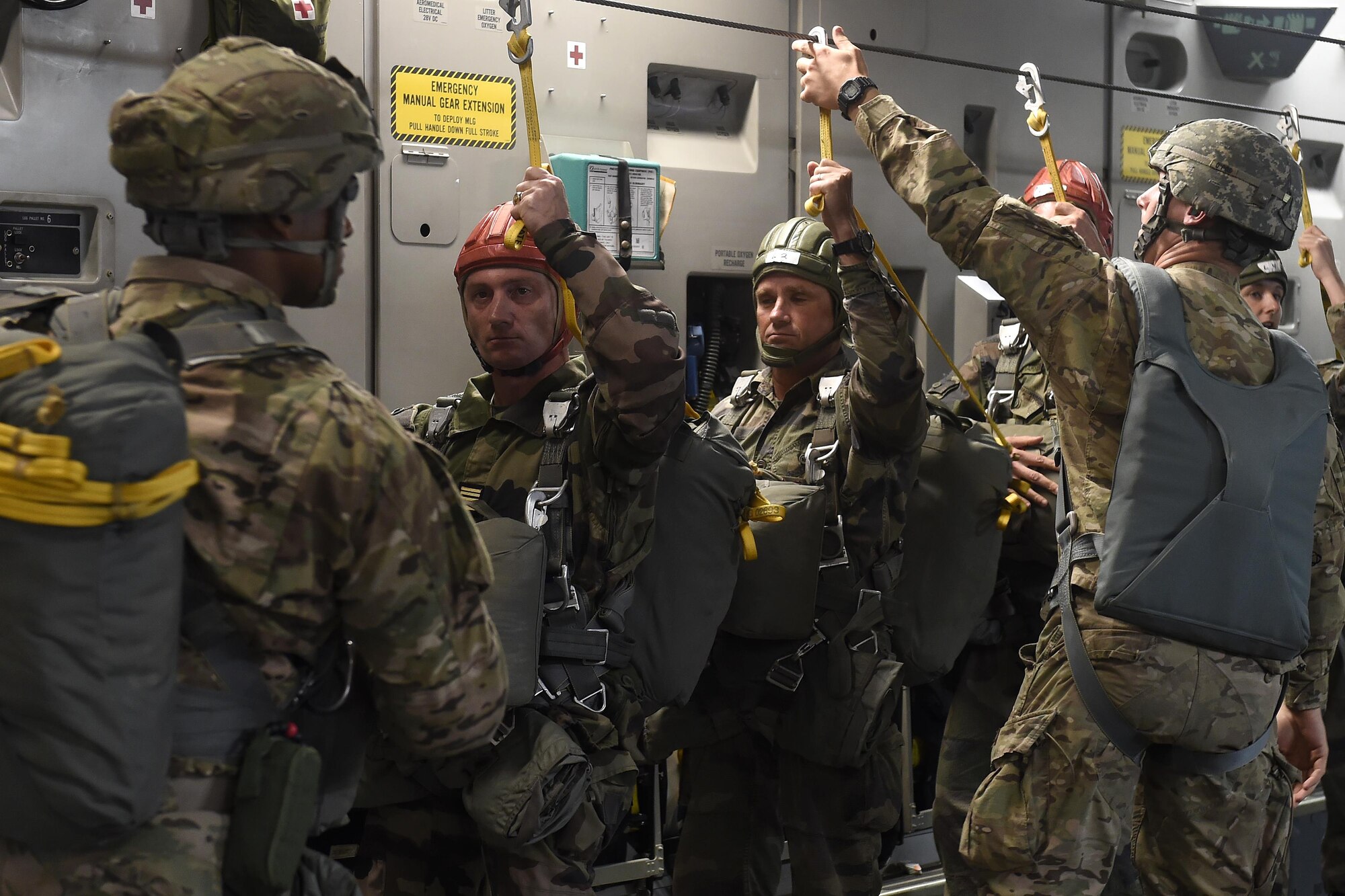 French paratroopers prepare for a static-line jump out of a 62nd Airlift Wing C-17 Globemaster III, stationed out of Joint Base Lewis-McChord, Wash., June 22, 2016, near Libreville, Gabon Africa during exercise Central Accord 2016. U.S. Army Africa's exercise Central Accord 2016 is an annual, combined, joint military exercise that brings together partner nations to practice and demonstrate proficiency in conducting peacekeeping operation. (U.S. Air Force photo/Tech. Sgt. Tim Chacon)