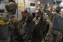 French paratroopers prepare for a static-line jump out of a 62nd Airlift Wing C-17 Globemaster III, stationed out of Joint Base Lewis-McChord, Wash., June 22, 2016, near Libreville, Gabon Africa during exercise Central Accord 2016. U.S. Army Africa's exercise Central Accord 2016 is an annual, combined, joint military exercise that brings together partner nations to practice and demonstrate proficiency in conducting peacekeeping operation. (U.S. Air Force photo/Tech. Sgt. Tim Chacon)