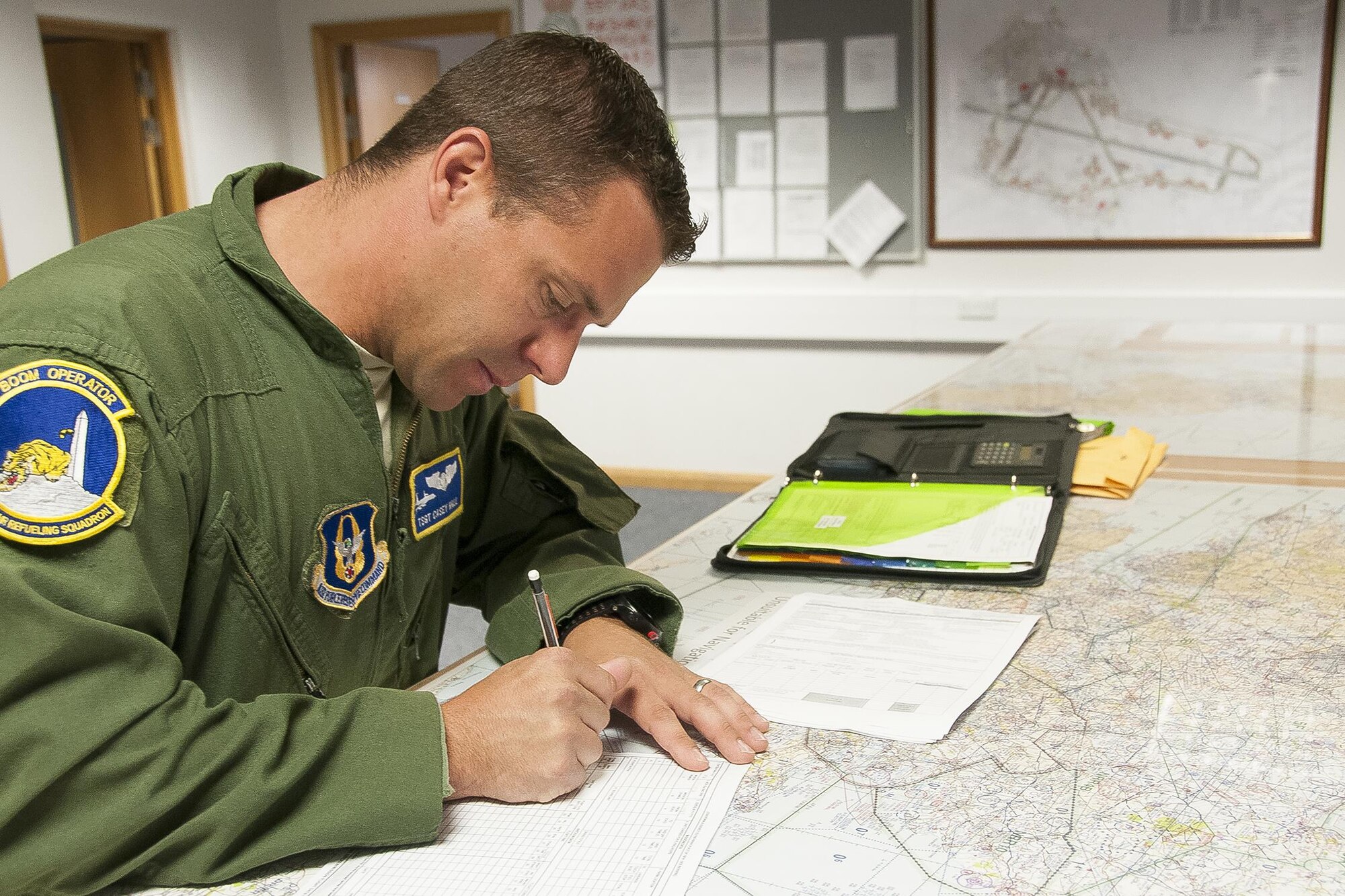 Technical Sgt. Casey Hall, 756th Air Refueling Squadron boom operator, fills out paperwork prior to a refueling mission at Royal Air Force Base Mildenhall, England, June 13, 2016. Boom operators play an integral role in pre-flight preparation and are responsible for fuel delivery from 459th Air Refueling Wing's KC-135R Stratotankers to various receivers. Members of the 459th ARW, to include pilots, boom operators and maintainers, are in England from mid-June to late July to help provide training and refueling support for Operation Atlantic Resolve. OAR aims to ensure peace and stability in Eastern Europe in the wake of Russia’s intervention in Ukraine.  (U.S. Air Force photo/Staff Sgt. Kat Justen)
