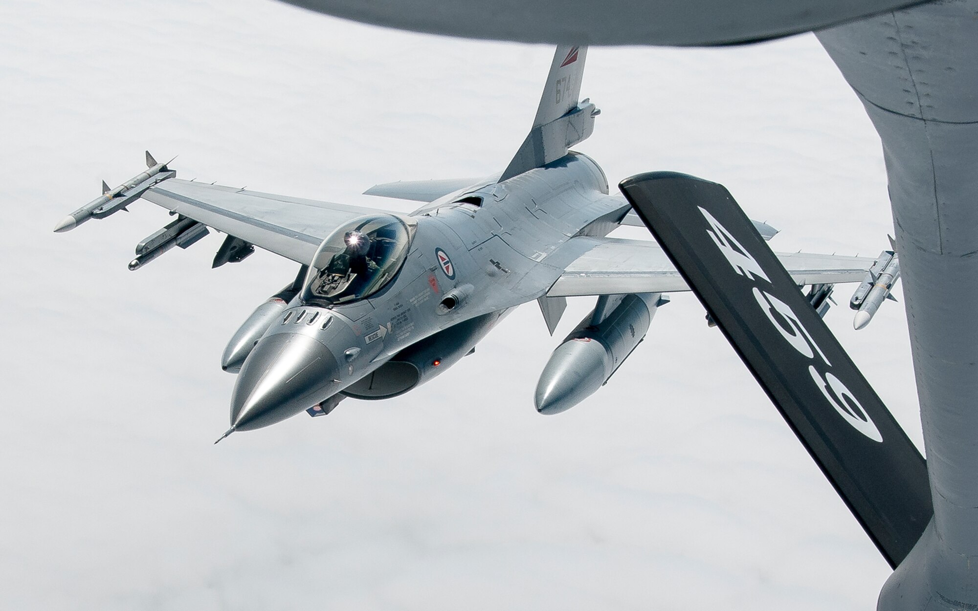 A Norwegian Air Force F-16 pulls away from the refueling boom of a 459th Air Refueling Wing KC-135R Stratotanker after an in-flight refueling over Norway June 13, 2016. Members of the 459th ARW, to include pilots, boom operators and maintainers, are in Europe from mid-June to late July to help provide training and refueling support for Operation Atlantic Resolve. OAR aims to ensure peace and stability in Eastern Europe in the wake of Russia’s intervention in Ukraine.  (U.S. Air Force photo/Staff Sgt. Kat Justen)