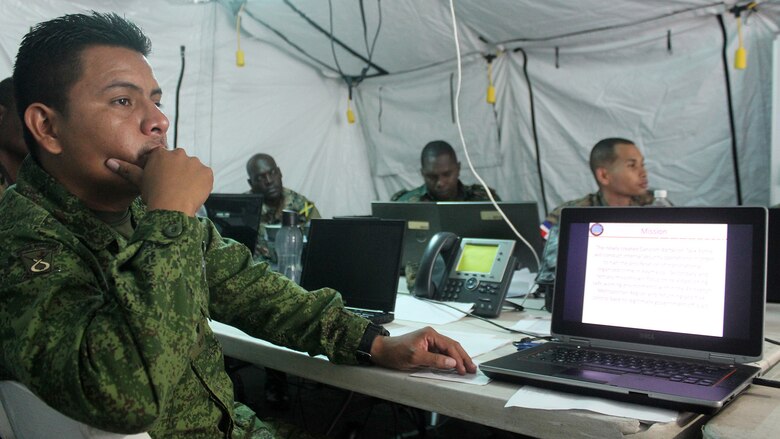 Capt. Edwin Oliva, executive officer of Operations, Belize Defense Force, listens to a brief on Command and Control during Phase II of exercise Tradewinds 2016, at Up Park Camp, Jamaica, June 24, 2016.  Tradewinds 2016 is a Chairman of the Joint Chiefs of Staff-approved, U.S. Southern Command-sponsored combined joint exercise conducted in conjunction with 17 partner nations to enhance the collective ability of their defense forces and constabularies to counter transnational organized crime and conduct humanitarian/disaster relief operations, while developing strong relationships and reinforcing human rights awareness.