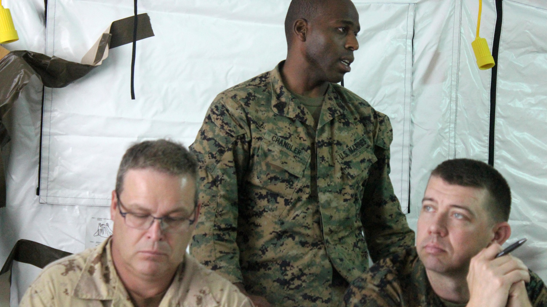 Gunnery Sgt. Sasha Chandler, intelligence analyst, briefs military officers participating in the command and control training of Phase II during exercise Tradewinds 2016, at Up Park Camp, Jamaica, June 24, 2016. Tradewinds includes both maritime and land phases, which will further enhance opportunities for participating countries to improve their security and disaster assistance capabilities.