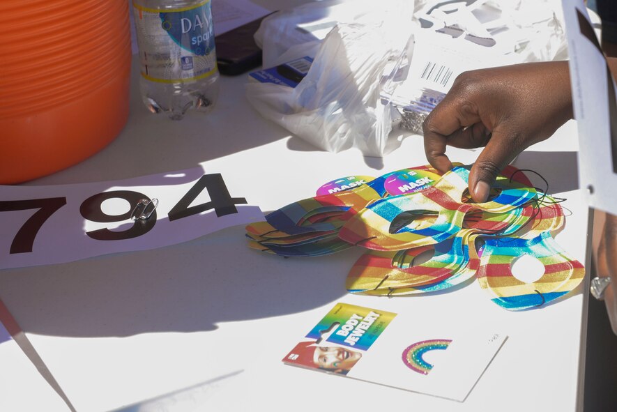 Rainbow masks and stickers are handed out to each participant of the Orlando memorial 5K at Minot Air Force Base, N.D., June 17, 2016. The race was organized by the Minot AFB Diversity Committee to pay respects to the 49 lives lost in the Orlando shooting June 12. (U.S. Air Force photo/Airman 1st Class Jessica Weissman)