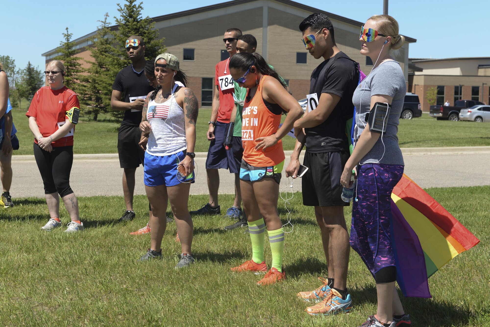 Members of Team Minot and the local community listen while names are read before a memorial 5K at Minot Air Force Base, N.D., June 17, 2016. The race was organized by the Minot AFB Diversity Committee to pay respects to the 49 lives lost in the Orlando shooting June 12. (U.S. Air Force photo/Airman 1st Class Jessica Weissman)