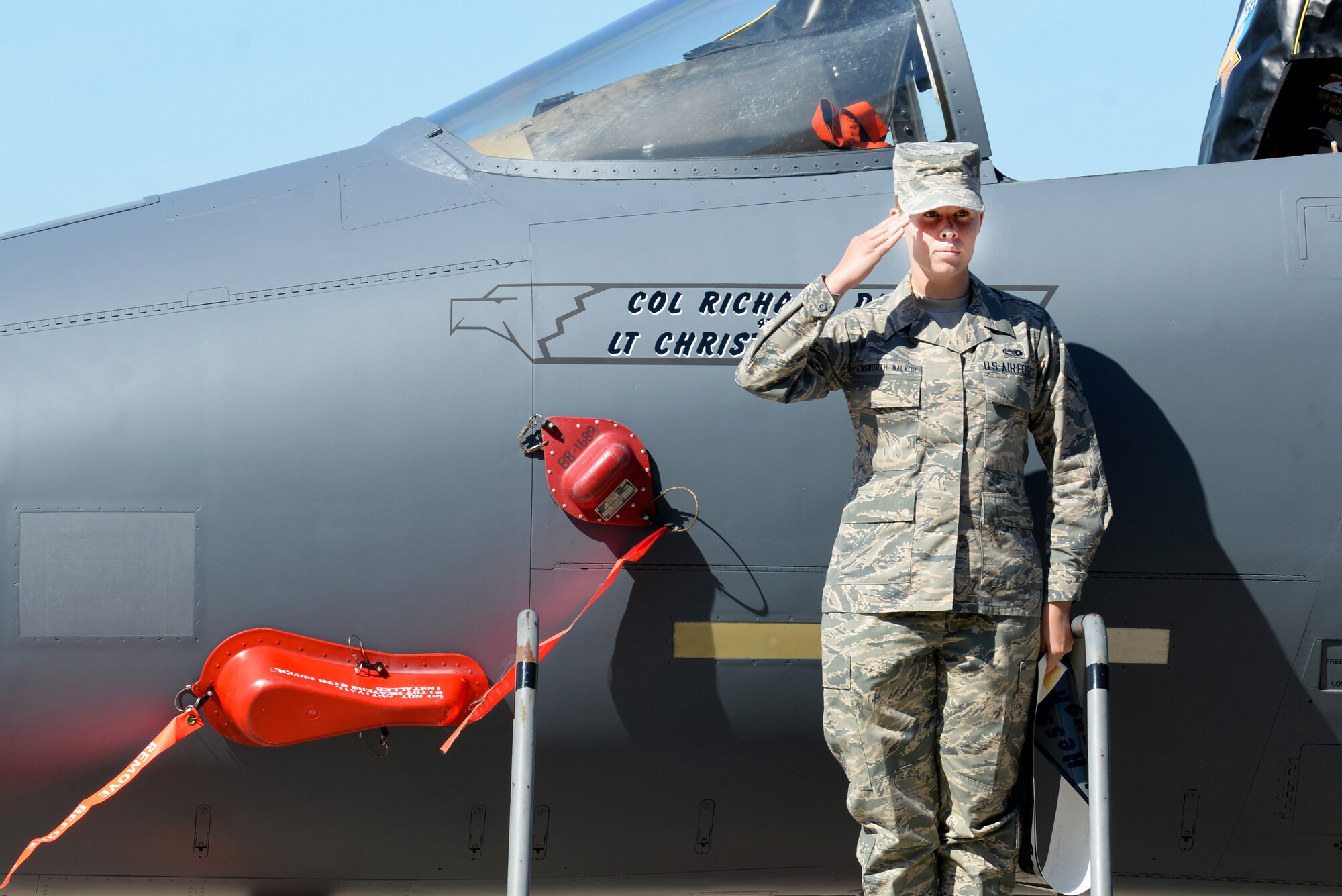 Airman 1st Class Nicole C. Ainsworth-Walkup, 4th Aircraft Maintenance Squadron assistant dedicated crew chief, renders a salute after revealing the name of Col. Richard Dickens, incoming 4th Operations Group commander, on an F-15E Strike Eagle, June 20, 2016, at Seymour Johnson Air Force Base, North Carolina. Dickens takes command of the 4th OG following an assignment at the National War College, Fort McNair, Washington D.C. (U.S. Air Force photo by Airman 1st Class Ashley Williamson