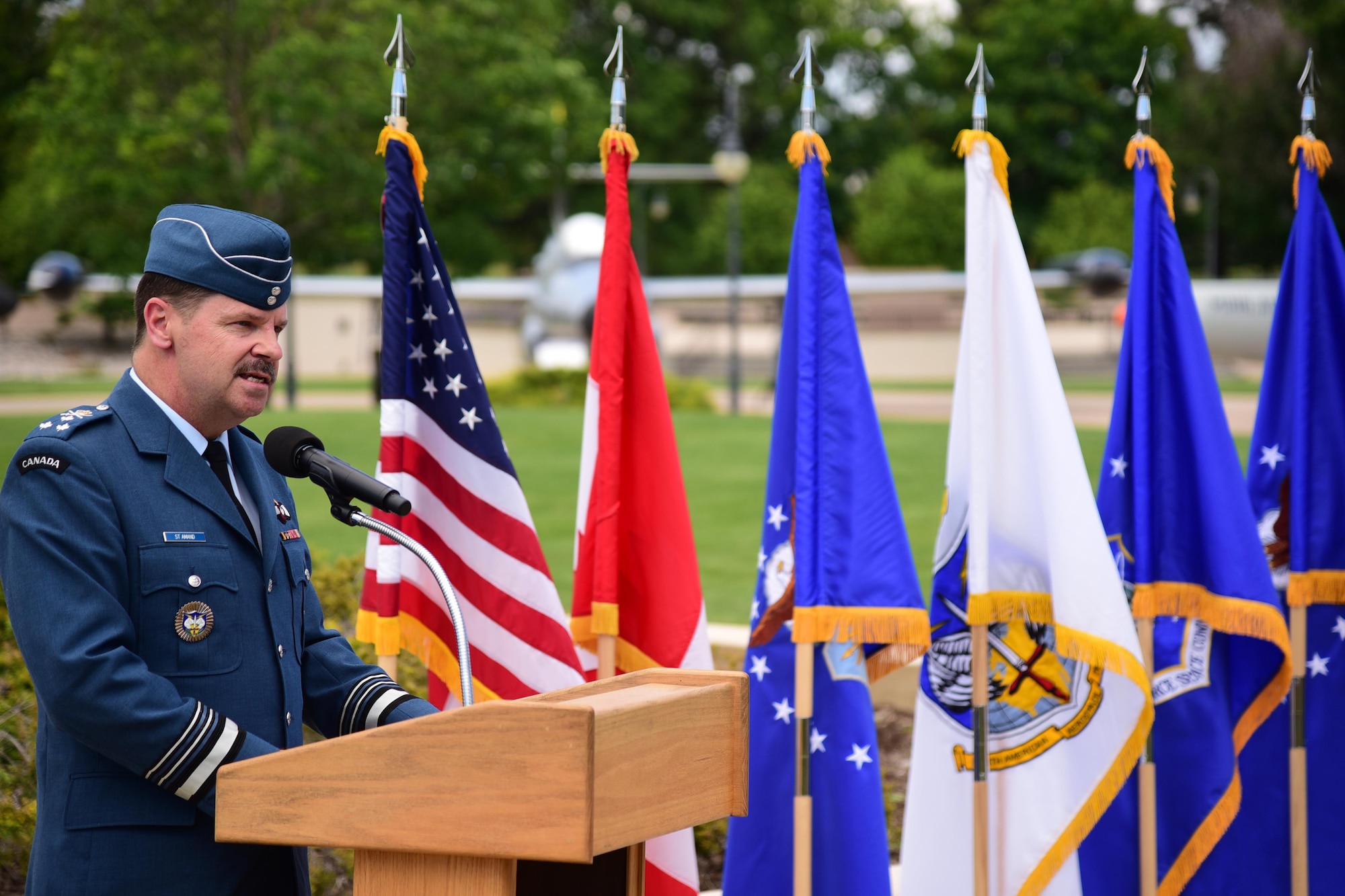 PETERSON AIF FORCE BASE, Colo. – Lt.-Gen. Pierre St-Amand, North American Aerospace Defense Command deputy commander, speaks at the dedication ceremony of a CF-188A Hornet to the U. S. Heritage Program at Peterson Air Force Base, Colo., June 24, 2016. The donation of this decommissioned aircraft was a gesture of appreciation for the longstanding and continued close relationship between Canada and the United States through NORAD. (U.S. Air Force photo by Staff Sgt. Amber Grimm)