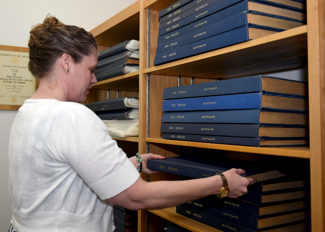 Shawn Riem, 30th Space Wing historian, retrieves historical documentation June 16, 2016, Vandenberg Air Force Base, Calif. Riem encourages all units to send her any mission documentation. This will allow her to assimilate pertinent information into her archives, as opposed to it being lost in the sands of time. (U.S. Air Force photo by Senior Airman Kyla Gifford/Released)