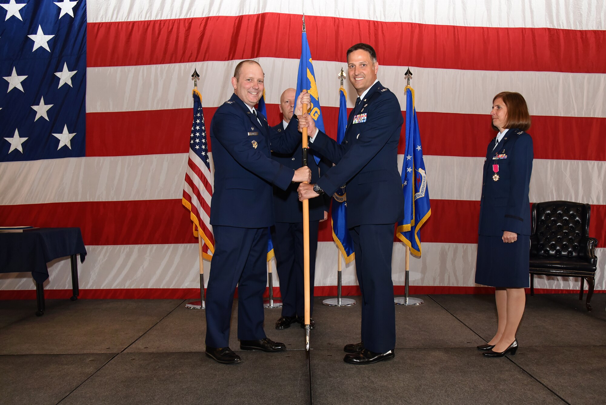 PETERSON AIR FORCE BASE, Colo. – Col. Scot Spann, 21st Medical Group incoming commander, receives the 21st MDG guidon from Col. Doug Schiess, 21st Space Wing commander, at Peterson Air Force Base, Colo., June 24, 2016. The 21st MDG is comprised of more than 550 medical professionals that provide healthcare and mission-readiness support for more than 26,000 active duty, retired and Department of Defense beneficiaries of the 21st SW, 50th SW, Colorado Springs community and 59 geographically separated units around the globe. (U.S. Air Force photo by Airman 1st Class Dennis Hoffman)