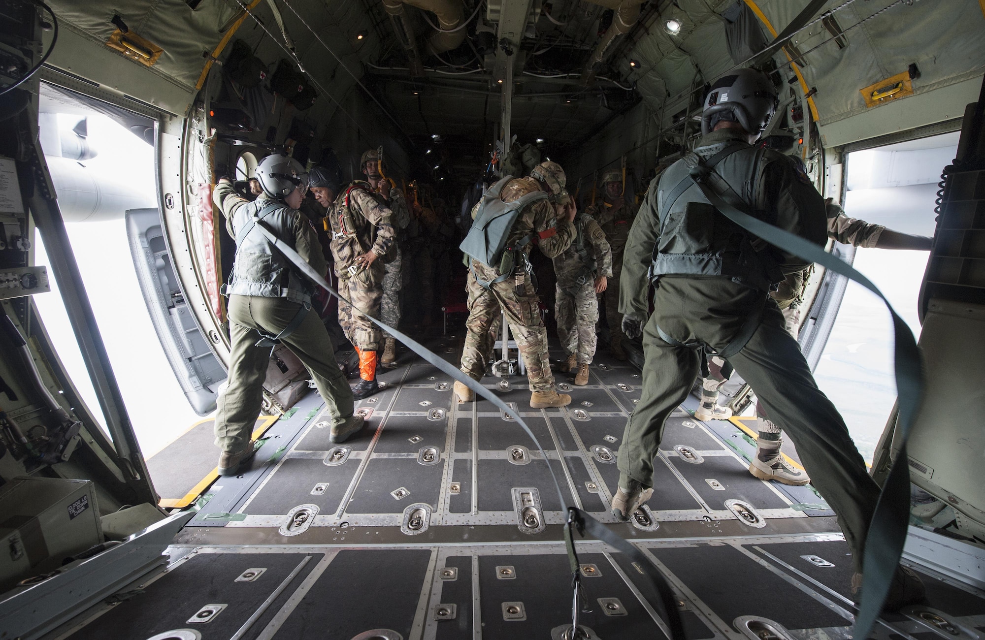 Paratroopers, with the U.S. Army’s 82nd Airborne Division, prepare to jump from a C-130 Hercules while Gabonese Defense Forces jumpmasters assist them with exiting the aircraft during exercise Central Accord 2016 in Libreville, Gabon, June 22, 2016. The U.S. Army Africa exercise is an annual, combined, joint military exercise that brings together partner nations to practice and demonstrate proficiency in conducting peacekeeping operations. (DOD photo/Tech. Sgt. Brian Kimball)