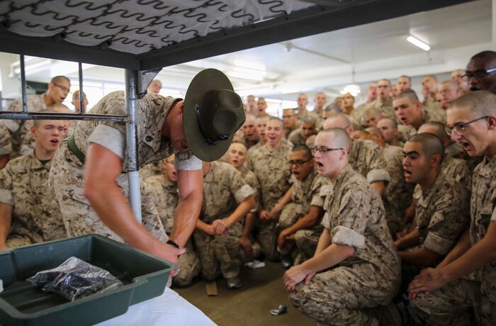 Staff Sgt. Rhett A. Buford, drill instructor, Charlie Company, 1st Recruit Training Battalion, teaches recruits how to properly make their racks during pick up at Marine Corps Recruit Depot San Diego, June 24. The new recruits also conducted an initial gear inspection to ensure they were prepared to begin training. Annually, more than 17,000 males recruited from the Western Recruiting Region are trained at MCRD San Diego. Charlie Company is scheduled to graduate Sept. 16.