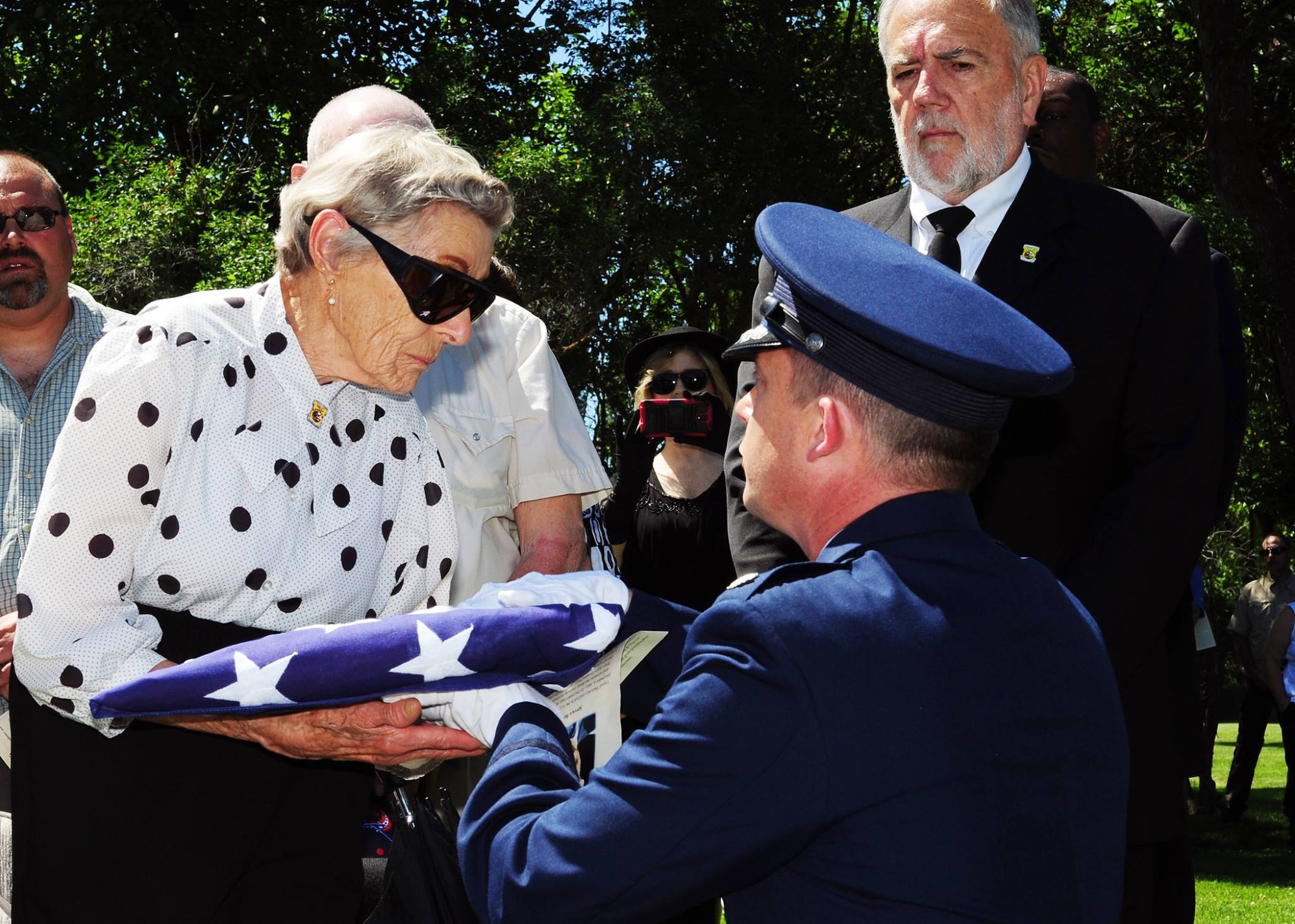 Lt. Col. Michael Epper, 341st Force Support Squadron commander, presents the flag to Dawn Thatcher, wife of Staff Sgt. David J. Thatcher, during a funeral service June 27 in Missoula, Mont. At 20 years old, Sgt. Thatcher was an engineer gunner in Flight Crew 7 of the Doolittle Tokyo Raids. His crew crash-landed into sea off the coast of China on April 18, 1942. Thatcher saved four members of the crew by pulling them to safety on the surrounding beach and applying life-saving medical treatment, even though he was injured himself. (U.S. Air Force photo by 2nd Lt. Annabel Monroe)