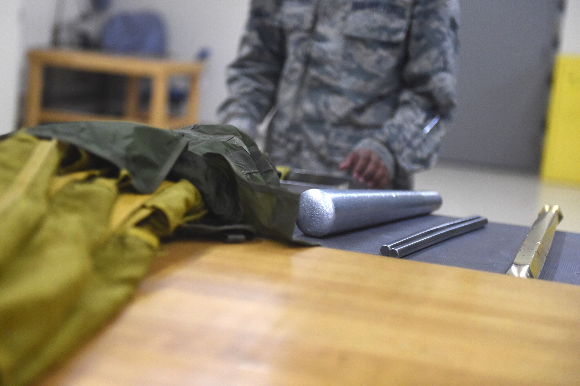 Airman 1st Class Dondrel, a 49th Operations Support Squadron aircrew flight equipment technician, places his packing tools near his work area at Holloman Air Force Base, N.M., July 21. AFE specialists ensure that pilots are equipped with supplies for any situation.  (Last names are being withheld due to operational requirements. U.S. Air Force photo by Staff Sgt. Eboni Prince)