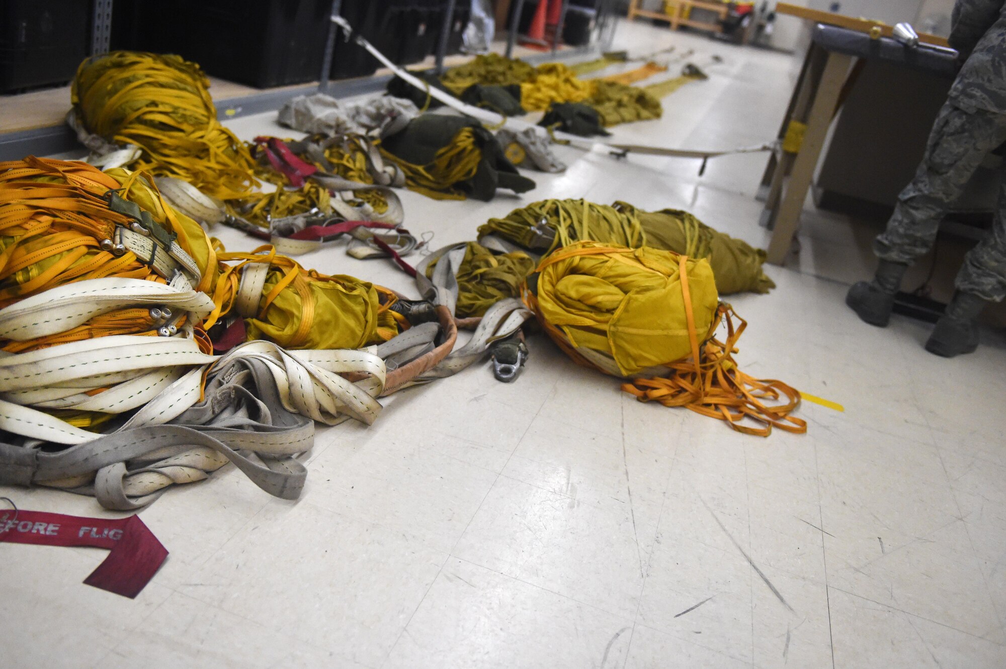 Several parachutes lie on the floor of the Aircrew Flight Equipment shop at Holloman Air Force Base, N.M., July 21. AFE personnel manage the inspection, maintenance and adjustments to the equipment assigned to the pilots they support. (Last names are being withheld due to operational requirements. U.S. Air Force photo by Staff Sgt. Eboni Prince)