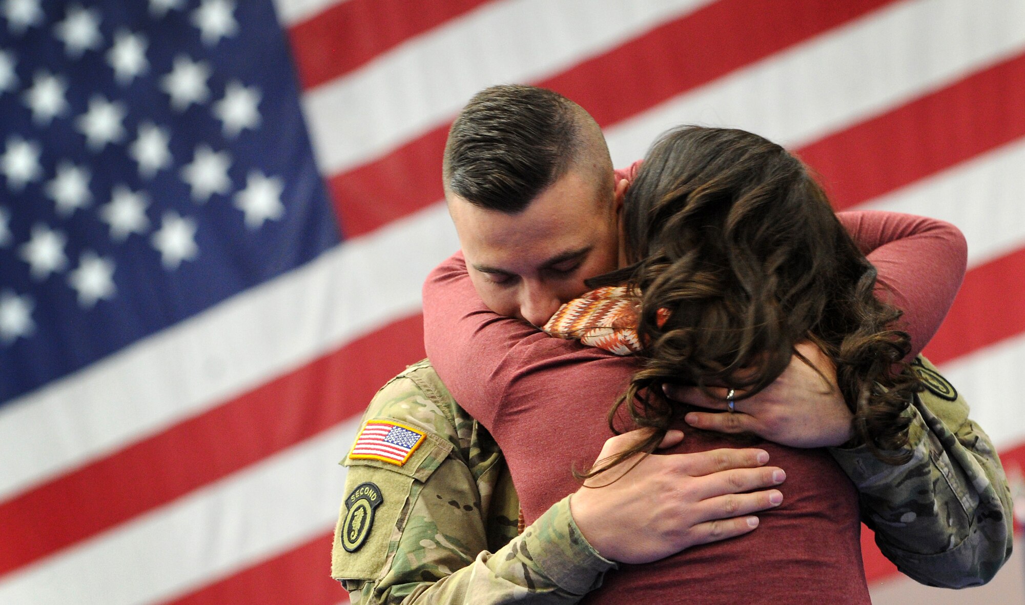 Army Spc. Jeffrey Metzger, a native of Buffalo, N.Y., embraces his wife Amelia after the welcome home ceremony for the 109th Transportation Company, 17th Combat Sustainment Support Battalion, 2d Engineer Brigade, at the Buckner Physical Fitness Center, Jan. 30, 2014, on Joint Base Elmendorf-Richardson, Alaska. The Military and Family Readiness Center mobilization and deployment readiness personnel’s mission is to develop an adaptable community in which service members and families are prepared for deployment, have access to the support they need throughout its course, and are prepared for the challenges that might occur when the service member returns from deployment.   