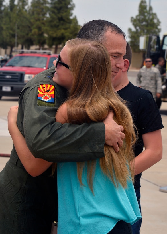 Brig. Gen. Scott Pleus, 56th Fighter Wing commander, receives a hug from his daughter after his final flight in an F-35 Lightning II June 27, 2016 at Luke Air Force Base, Ariz. His two-year tenure as commander was filled with change as the wing shifted its mission to include the F-35.(U.S. Air Force photo by Senior Airman Devante Williams)