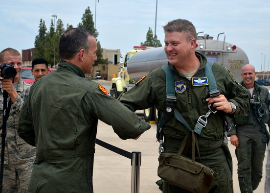 Brig. Gen. Scott Pleus, 56th Fighter Wing commander, is congratulated by Col. David Shoemaker, 56th Fighter Wing vice commander, after his final flight in an F-35 Lightning II June 27, 2016 at Luke Air Force Base, Ariz. His two-year tenure as commander was filled with change as the wing shifted its mission to include the F-35. (U.S. Air Force photo by Senior Airman Devante Williams)