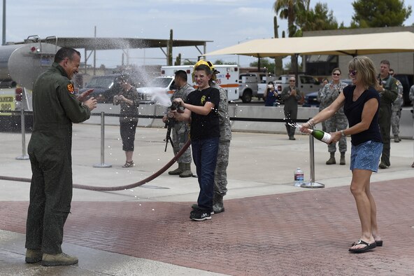 Brig. Gen. Scott Pleus, 56th Fighter Wing commander, is greeted by his family after his final flight in an F-35 Lightning II June 27, 2016. His two-year tenure as commander was filled with change as the wing shifted its mission to include the F-35. (U.S. Air Force photo by Staff Sgt. Staci Miller)
