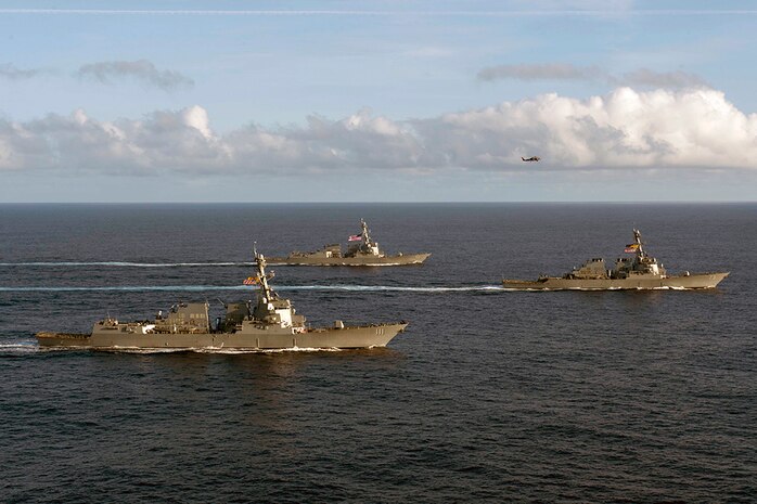 In this file photo, the Arleigh Burke class guided-missile destroyer USS Spruance (DDG 111) (front) steams in formation with USS Decatur (DDG 73) and USS Momsen (DDG 92). Spruance, along with guided-missile destroyers USS Momsen (DDG 92) and USS Decatur (DDG 73), and embarked “Devil Fish” and “Warbirds” detachments of Helicopter Maritime Strike Squadron (HSM) 49, deployed as part of a U.S. 3rd Fleet Pacific Surface Action Group (PAC SAG) under Destroyer Squadron (CDS) 31.