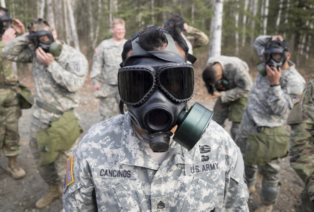 Army Staff Sgt. Henry Cancinos conducts chemical, biological, radiological and nuclear defense training at Joint Base Elmendorf-Richardson, Alaska, April 13, 2016. The training culminated with masked soldiers entering a sealed chamber filled with tear gas and then removing their protective gear to promote confidence in their equipment. Cancinos is assigned to the 25th Infantry Division’s Bravo Troop, 1st Squadron (Airborne), 40th Cavalry Regiment. Air Force photo by Justin Connaher