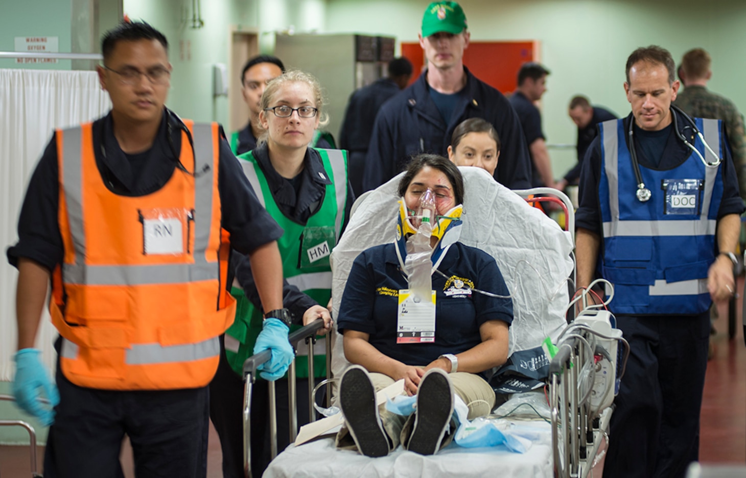PHILIPPINES SEA (June 24, 2016) Personnel transport a patient with simulated injuries during a mass casualty drill aboard hospital ship USNS Mercy (T-AH 19). Deployed in support of Pacific Partnership 2016, medical, engineering and various other personnel embarked aboard Mercy are working side-by-side with partner nation counterparts, exchanging ideas, building best practices and relationships to ensure preparedness should disaster strike.
