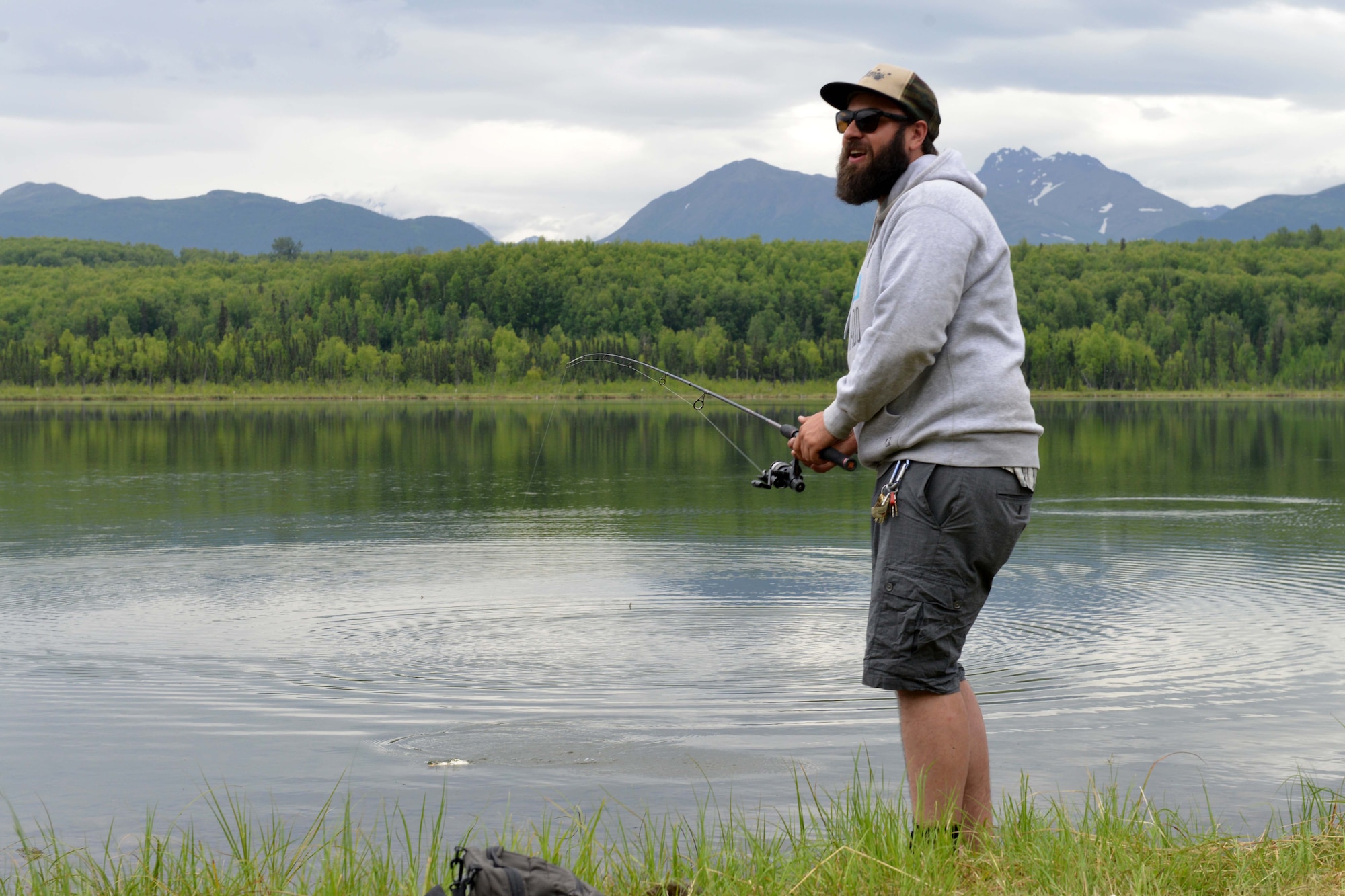 Trevor Bird, Otter Lake manager, laughs after catching a rainbow trout on his first try at the Introduction to Fishing Class, at Otter Lake at Joint Base Elmendorf-Richardson, Alaska, June 23, 2016. Trevor is an avid fisher of more than 23 years. (U.S. Air Force photo by Airman 1st Class Javier Alvarez)