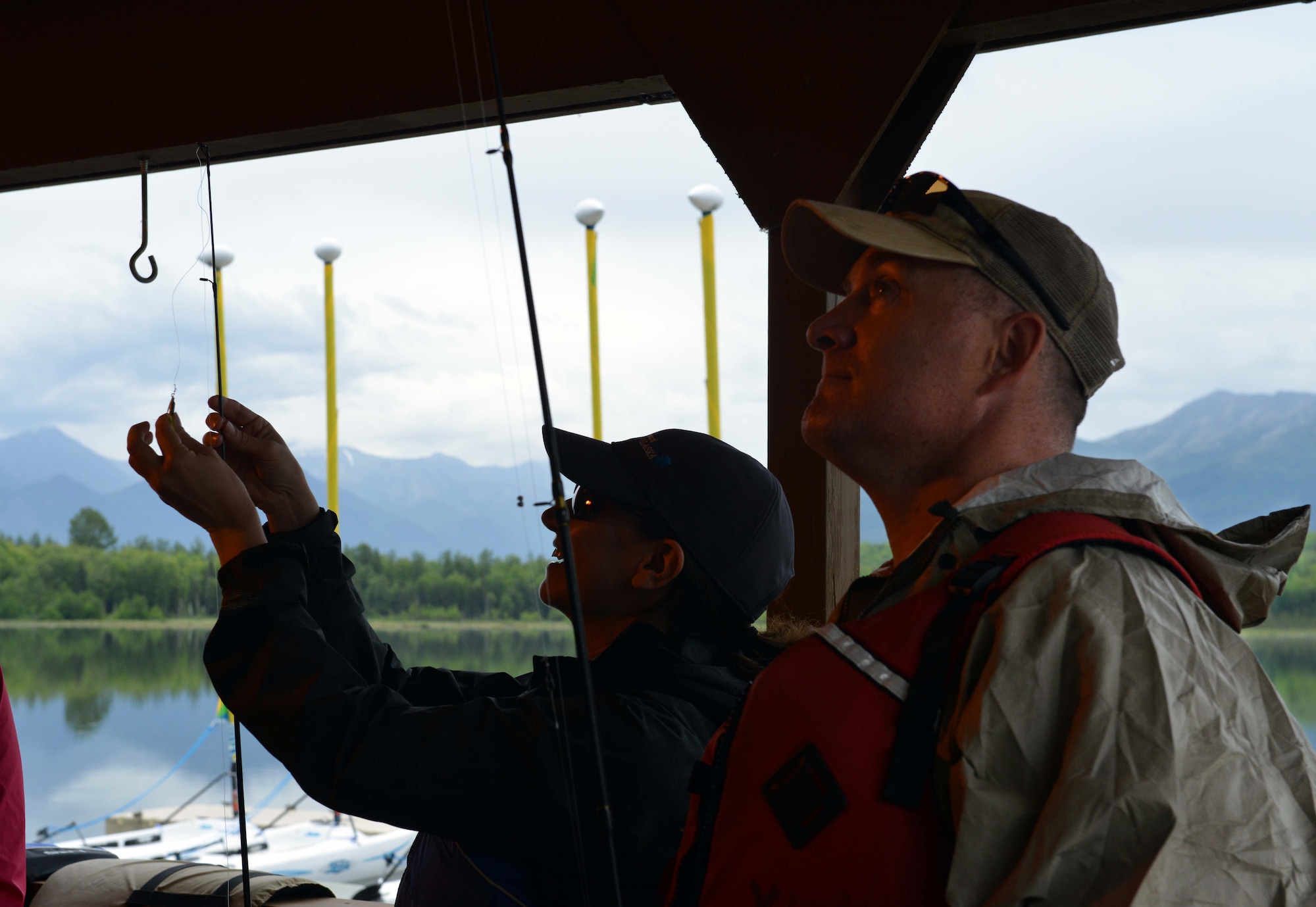 Joe Palmer, a Navy reservist, and Crystal Palmer, listen as Trevor Bird discusses the basics of casting at the Introduction to Fishing Class, at Otter Lake at Joint Base Elmendorf-Richardson, Alaska, June 23, 2016. Guides with fishing regulations can be found at the JBER Exchange, and most sporting goods stores. (U.S. Air Force photo by Airman 1st Class Javier Alvarez)