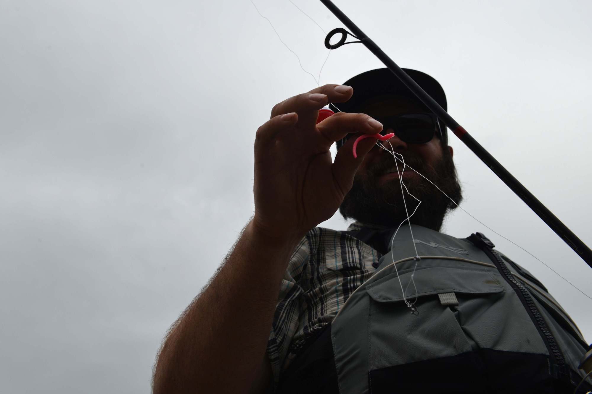 Trevor Bird, Otter Lake manager, shows off the bait he’s preparing to use as part of the Introduction to Fishing Class, at Otter Lake at Joint Base Elmendorf-Richardson, Alaska, June 23, 2016. Otter Lake was stocked with rainbow trout for the first time in nine years. (U.S. Air Force photo by Airman 1st Class Javier Alvarez)
