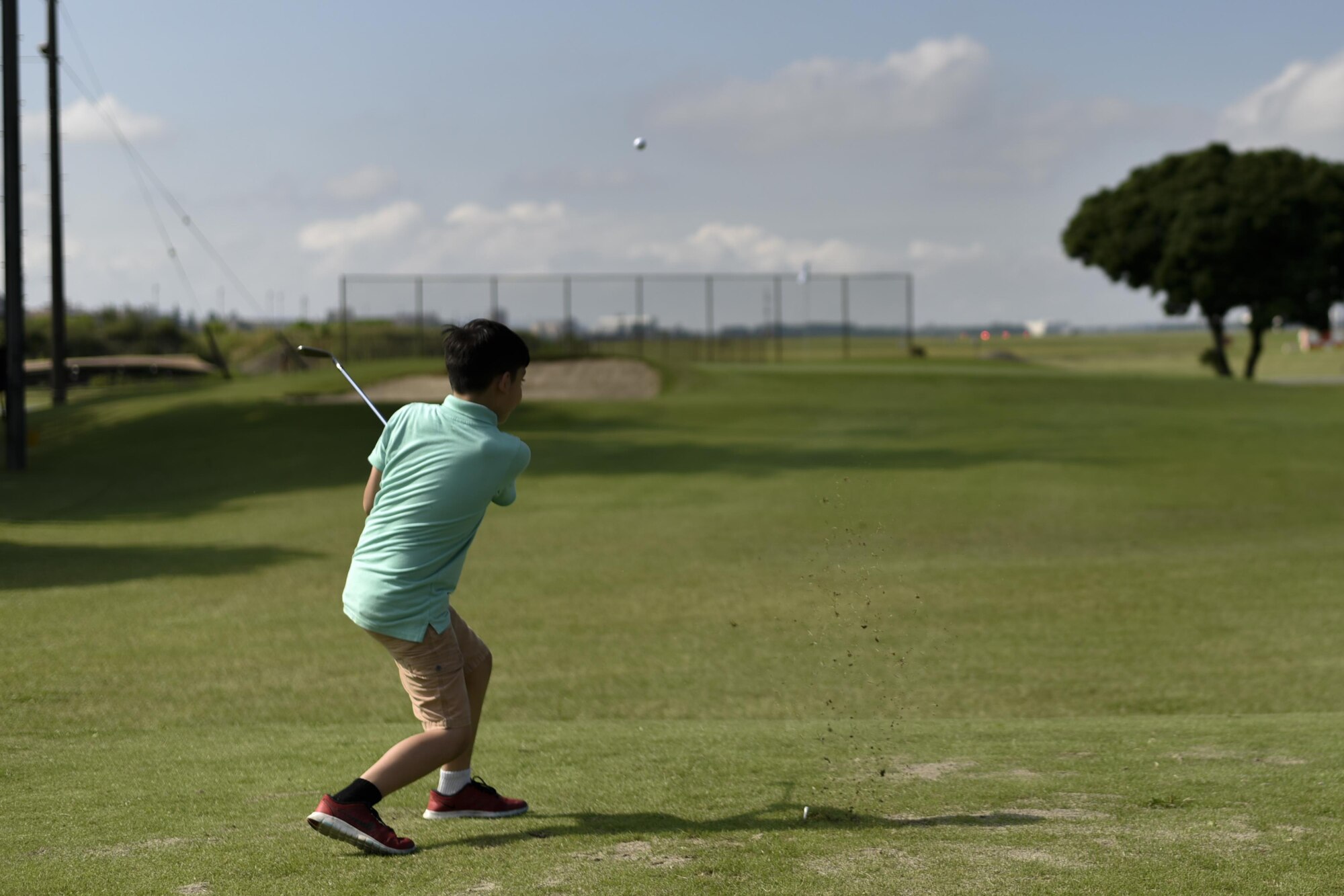 Marcos Gueits, event participant, hits a golf ball during the Ladies Professional Golf Association golf clinic at Yokota Air Base, Japan, June 23, 2016. The golf clinic started four years ago with one base and has since expanded to 22 bases throughout the year. (U.S. Air Force photo by Staff Sgt. Michael Washburn/Released)