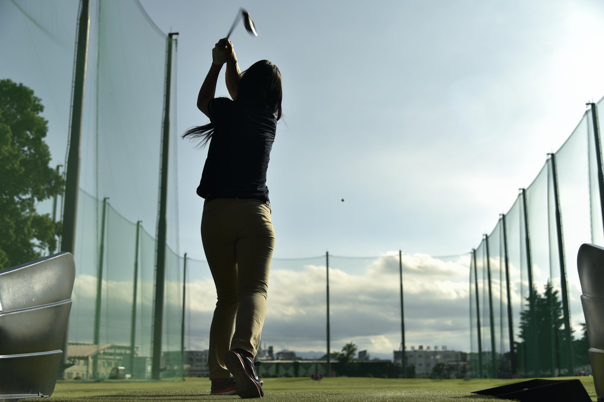 Ayako Gutierrez, event participant, hits a ball at the driving range during the Ladies Professional Golf Association golf clinic at Yokota Air Base, Japan, June 23, 2016. The clinic used the driving range as well as the Par 3, which allowed those who participated to practice any aspect of their game. (U.S. Air Force photo by Staff Sgt. Michael Washburn/Released)