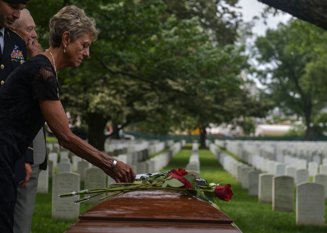 Judi Boyer-Bouchard places a rose on her brother, returned Sgt. 1st Class Alan Boyer’s casket during his funeral service held at the Arlington National Cemetery, June 22, 2016. Boyer was buried with full military honors, and will forever be laid to rest surrounded by his brother and sisters in arms in the Arlington National Cemetery, including his best friend U.S. Army 1st Lt. Loren Hagen who is buried a few plots away from Boyer’s final resting place. “I extend my heartfelt thanks for your prayers and support for Alan and my family for so many years. Special thanks to those dedicated and committed to pursuing the fullest possible accounting for Americans still missing from the Vietnam War.” Boyer-Bouchard. 