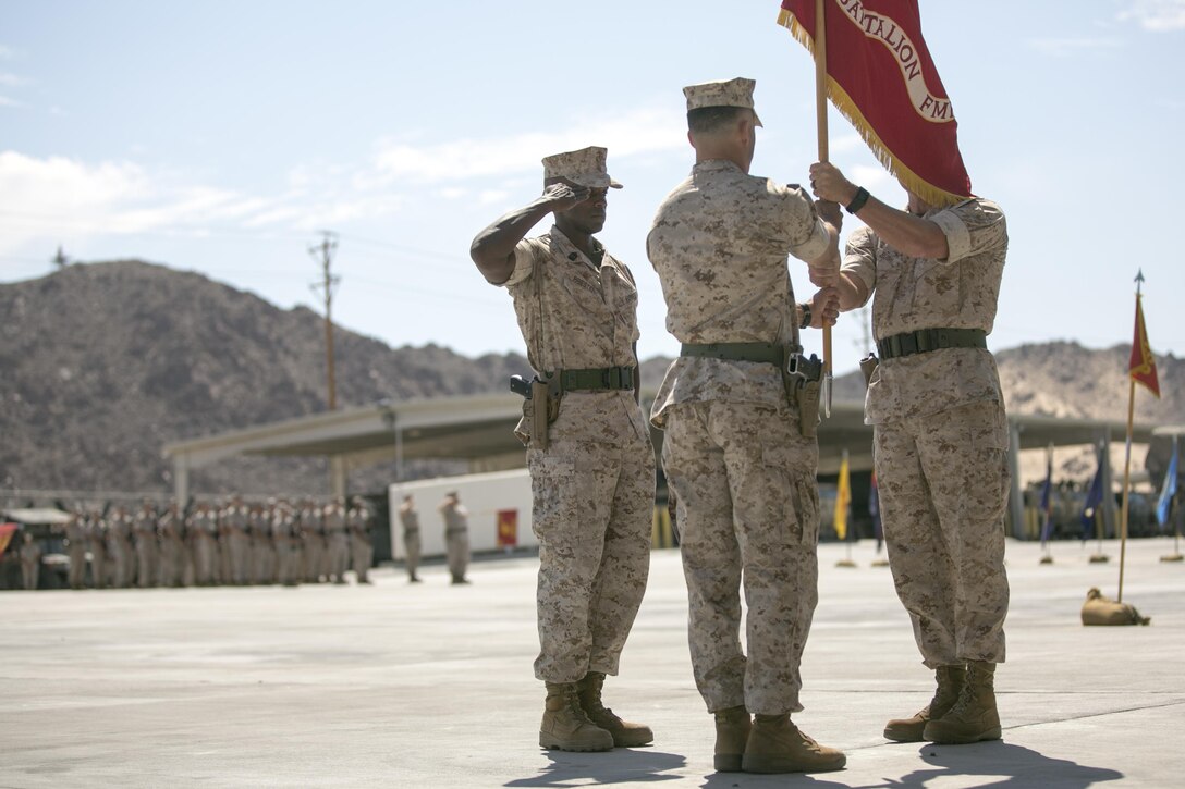 Lt. Col. Lee Rush, right, passes the battalion’s colors to Lt. Col. Christopher Meyers, left, during 1st Tank Battalion’s change of command ceremony at the tank ramp, June 22, 2016. The passing of the battalion colors symbolizes the passing of command and responsibilities from the outgoing to the on-coming commanding officer. (Official Marine Corps photo by Cpl. Thomas Mudd/Released)