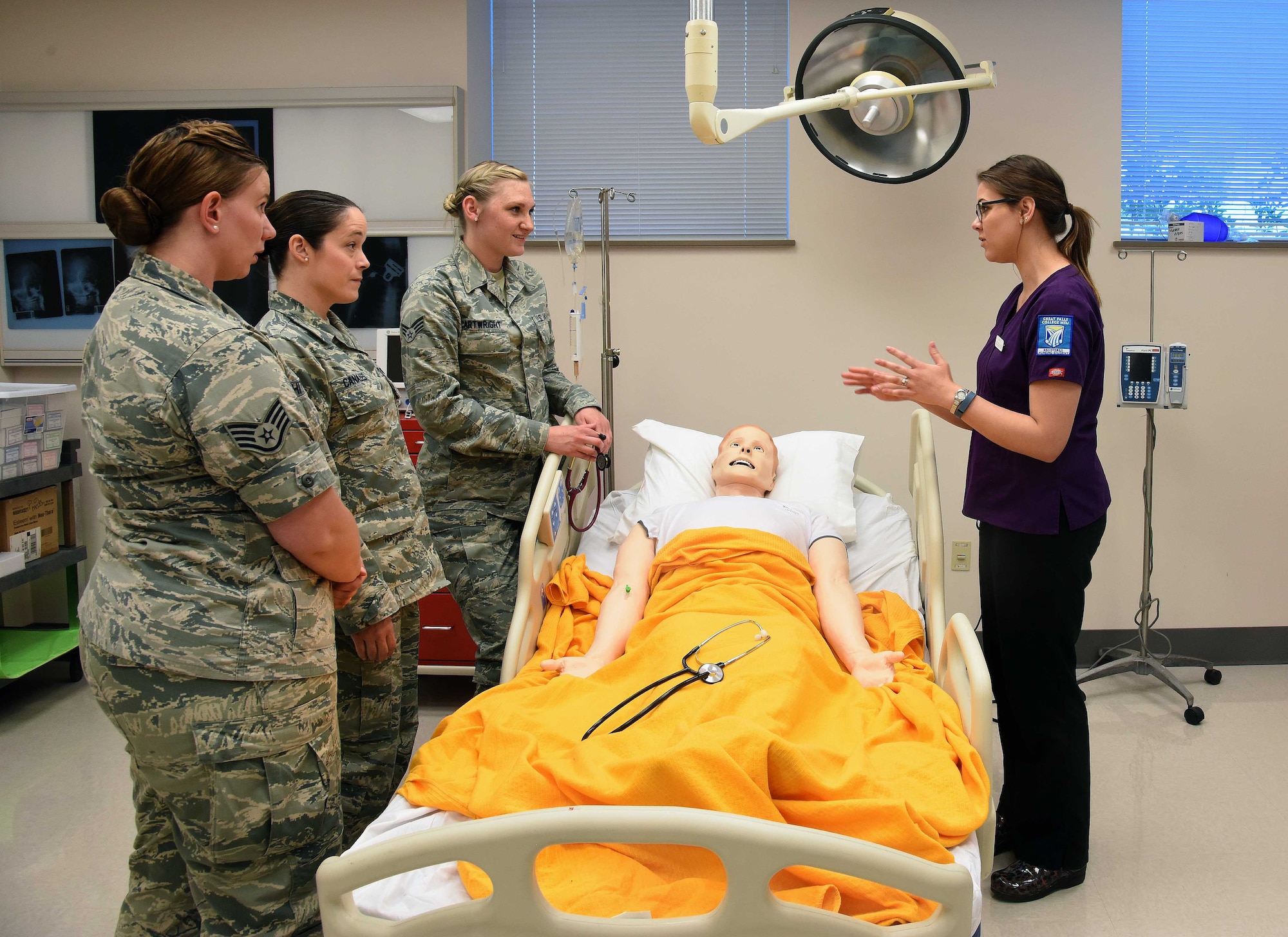 Sarah Ford, Great Falls College—Montana State University second year registered nursing student, trains with members of Malmstrom Air Force Base June 23, 2016, at Great Falls College, Mont. The training allowed members from the 341st Medical Group to work and learn alongside their civilian counterparts on head-to-toe assessments, different code situations and will be held once a month for each of the modules. (U.S. Air Force photo/Senior Airman Jaeda Tookes)