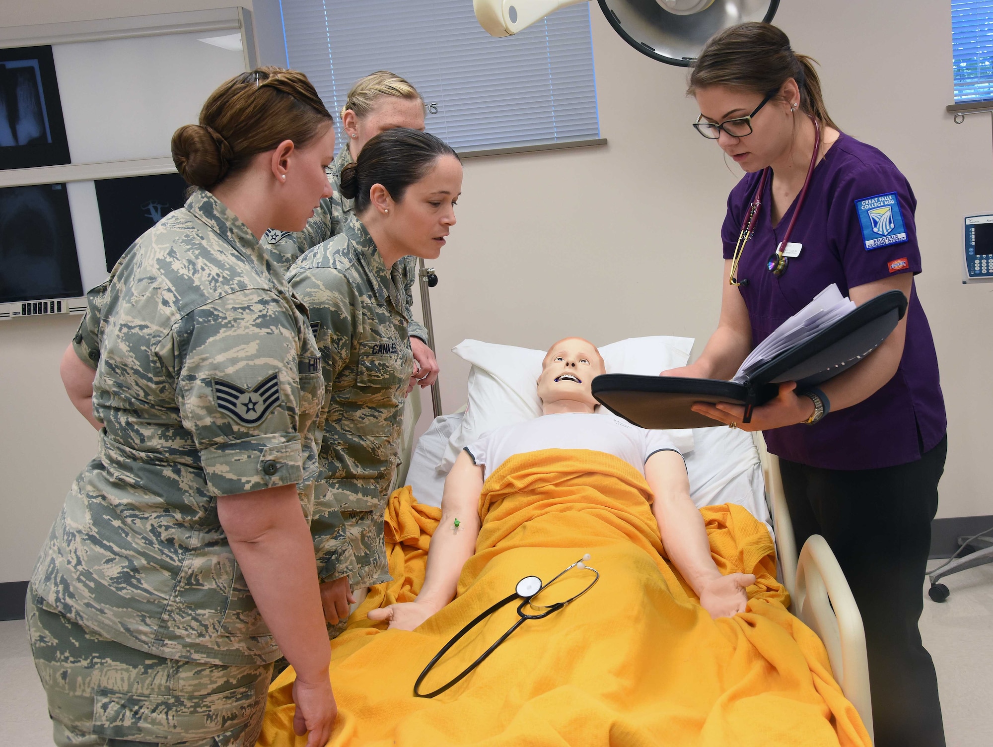 Great Falls College—Montana State University second year registered nursing students and members of Malmstrom Air Force Base train jointly June 23, 2016, at Great Falls College, Mont. Members were trained on head-to-toe assessments, different code situations and intravenous starts. (U.S. Air Force photo/Senior Airman Jaeda Tookes)