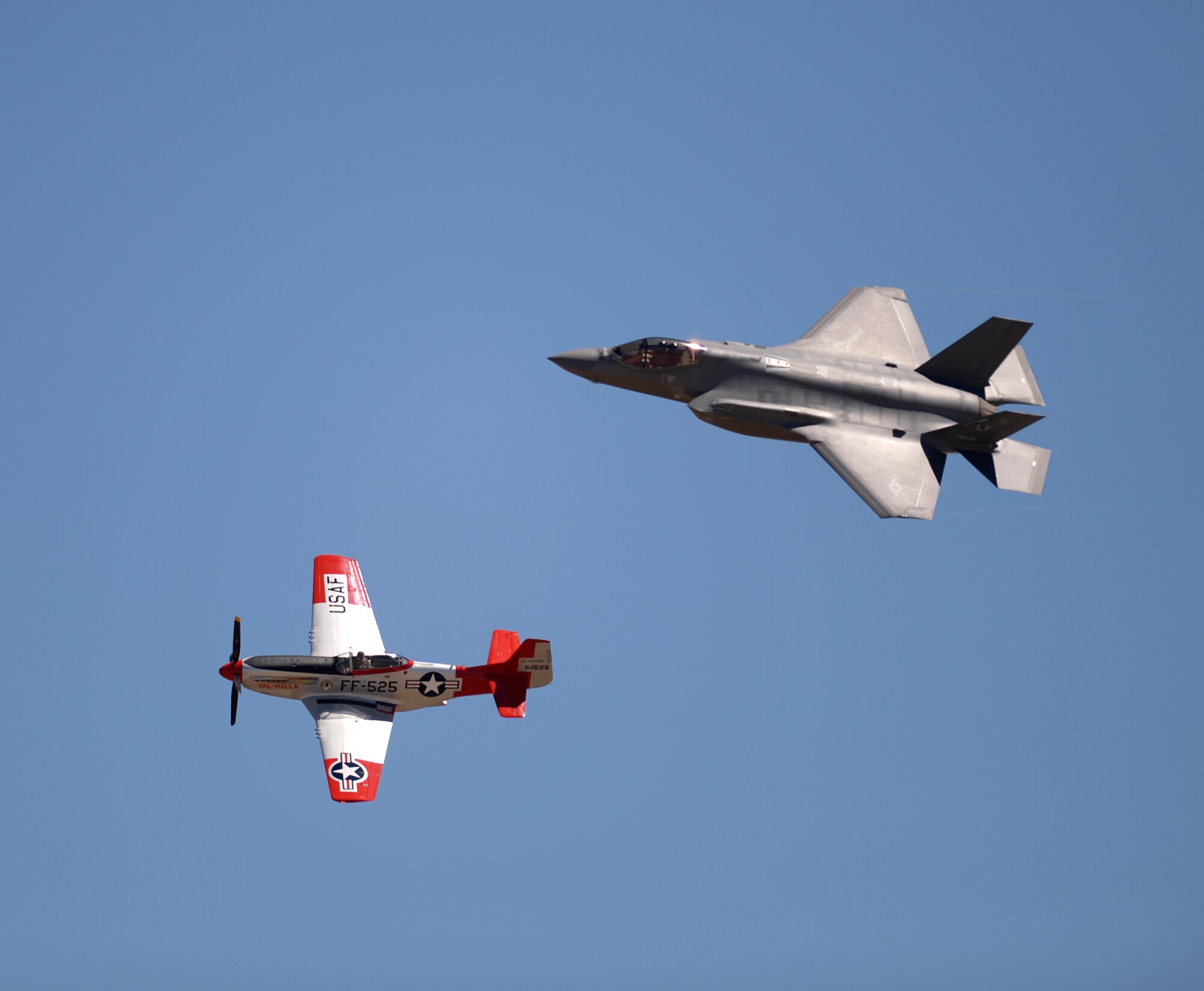 An F-35 Lightning II and a vintage P-51 aircraft perform for spectators during the Warriors Over the Wasatch Air Show and Open House June 26 at Hill Air Force Base, Utah. The Air Combat Command Air Force Heritage Flight program features modern U.S. Air Force fighter aircraft flying alongside World War II, Korean-era, and Vietnam-era aircraft in a dynamic display of our nation’s airpower history. (U.S. Air Force photo by Todd Cromar)