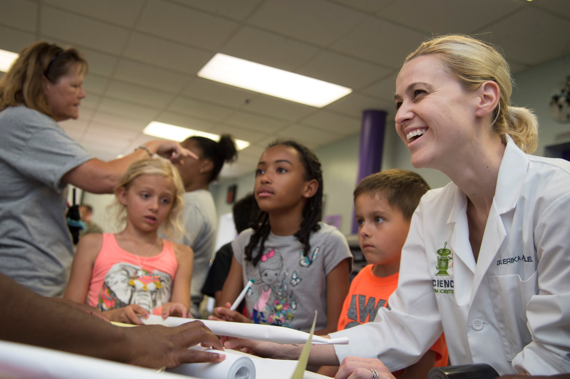 Dr. Erika Angle, Science from Scientists founder and executive director, works with children at the opening of the Center of Innovation at the Joint Base Andrews Youth Center, here, June 24, 2016. The center gives the students the opportunity to create something or experiment, while in a safe and supervised environment. (U.S. Air Force photo by Senior Airman Mariah Haddenham)
