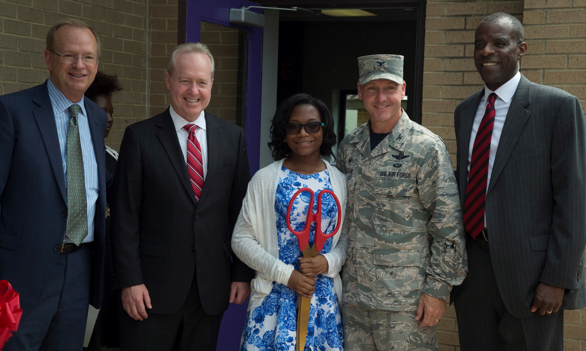 Jim Clark, Boys and Girls Clubs of America president and CEO (left), Tom Kennedy, Raytheon chairman and CEO, Desha Jenkins, Andrews Revolution Keystone Club president and teen volunteer, Col. Bradley Hoagland, 11th Wing and Joint Base Andrews commander, and Vincent Eure, 11th Force Support Squadron youth programs section chief, pose for a photo during the opening of the Center of Innovation at the Joint Base Andrews Youth Center, here, June 24, 2016. The center’s goal is to excite children about science, technology, engineering, and math subjects, also known as STEM. (U.S. Air Force photo by Senior Airman Mariah Haddenham)