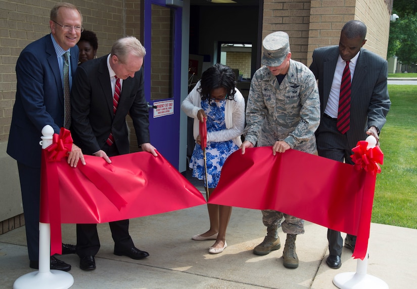 Desha Jenkins, Andrews Revolution Keystone Club president and teen volunteer, cuts the ribbon at the opening of the Center of Innovation at the Joint Base Andrews Youth Center, here, June 24, 2016. The center’s goal is to excite children about science, technology, engineering, and math subjects, also known as STEM. (U.S. Air Force photo by Senior Airman Mariah Haddenham)