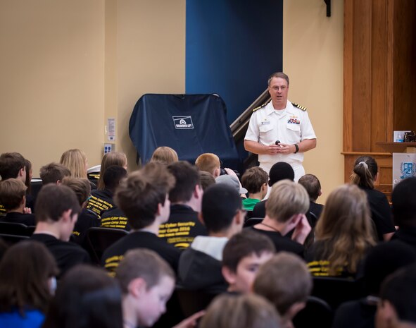 SPAWAR Systems Center (SSC) Atlantic commanding officer Scott Heller speaks to more than 80 middle school students attending the SSC Atlantic sponsored cybersecurity summer camp at the Lowcountry Tech Academy of Charleston County in Charleston, S.C. During the week long camp over 30 volunteers from SSC Atlantic exposed and challenged the students in cyber espionage, computer deconstruction, command and control systems, internet security, snap circuits and scratch programming among other activities. (U.S. Navy photo/Joe Bullinger)