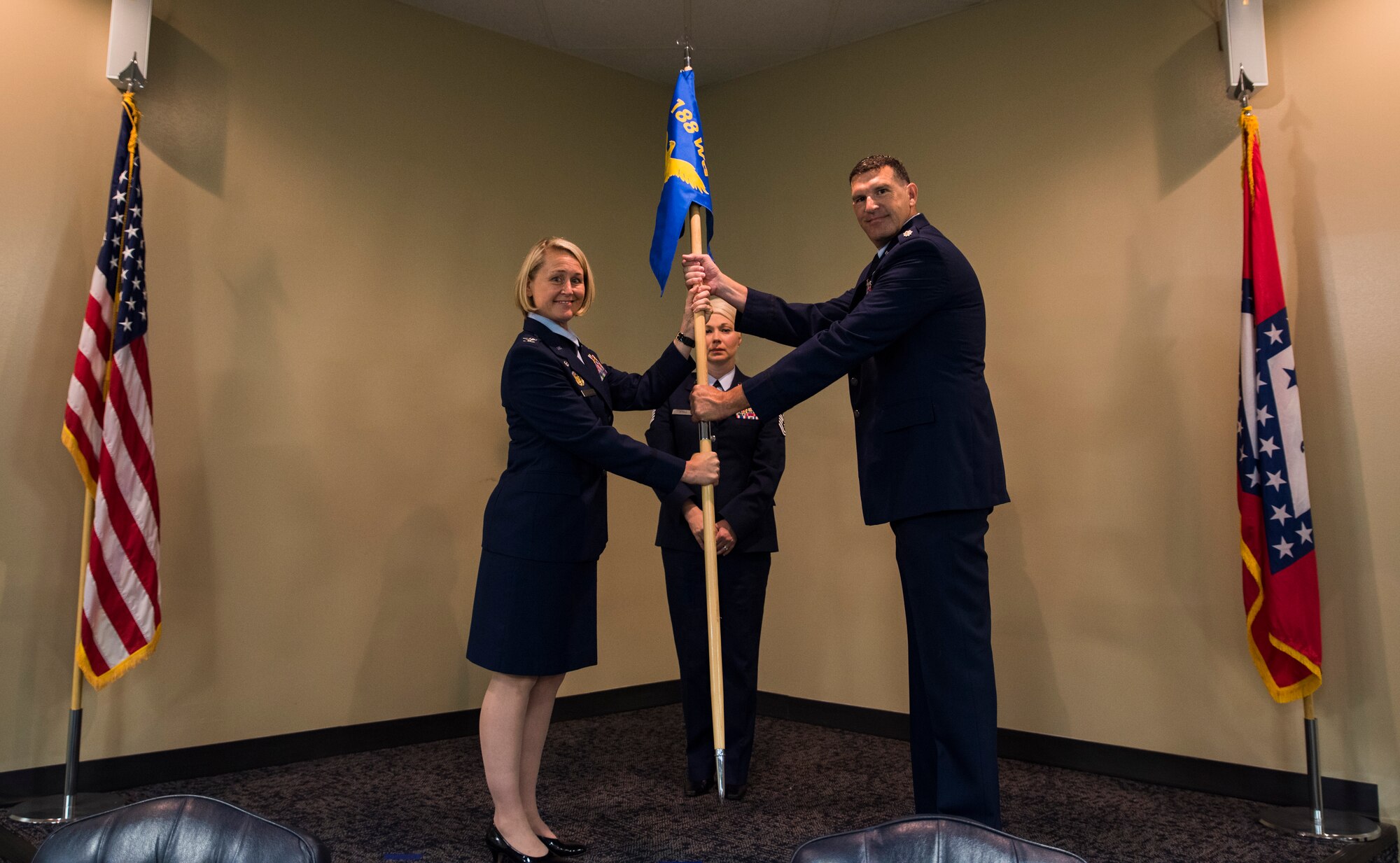 Lt. Col. Leon Dodroe receives the flag from Col. Bobbi Doorenbos, 188th Wing commander, as he assumes command of the 188th Operations Group June 26, 2016, Ebbing Air National Guard Base, Fort Smith, Ark. As commander, Dodroe will complete the wing’s mission conversion to the MQ-9 Reaper and continue the custom of professionalism and dedication within the 188th OG. (U.S. Air National Guard photo by Senior Airman Cody Martin/Released)