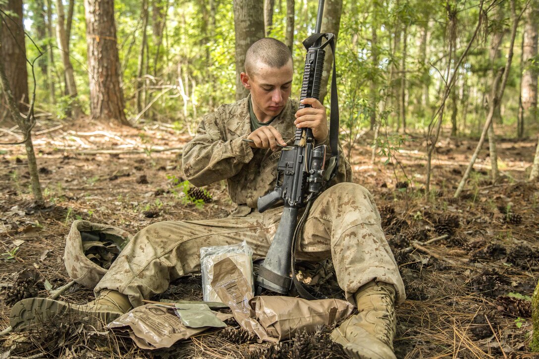 Marine Corps recruit Tyler Steeley cleans his weapon during the Crucible at Marine Corps Recruit Depot Parris Island, S.C., June 24, 2016. Marine Corps photo by Lance Cpl. Colby Cooper