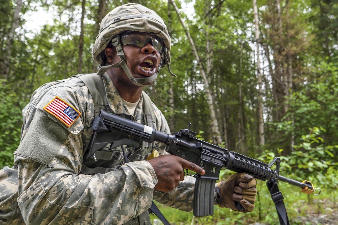 Army Spc. Gerald Wilson yells a warning about incoming indirect fire to his team during the Ready Warrior Competition at Camp Madbull on Joint Base Elmendorf-Richardson, Alaska, June 23, 2016.  The three-day competition tested teams' physical fitness, small-arms proficiency, land navigation and small-unit tactics. Air Force photo by Justin Connaher