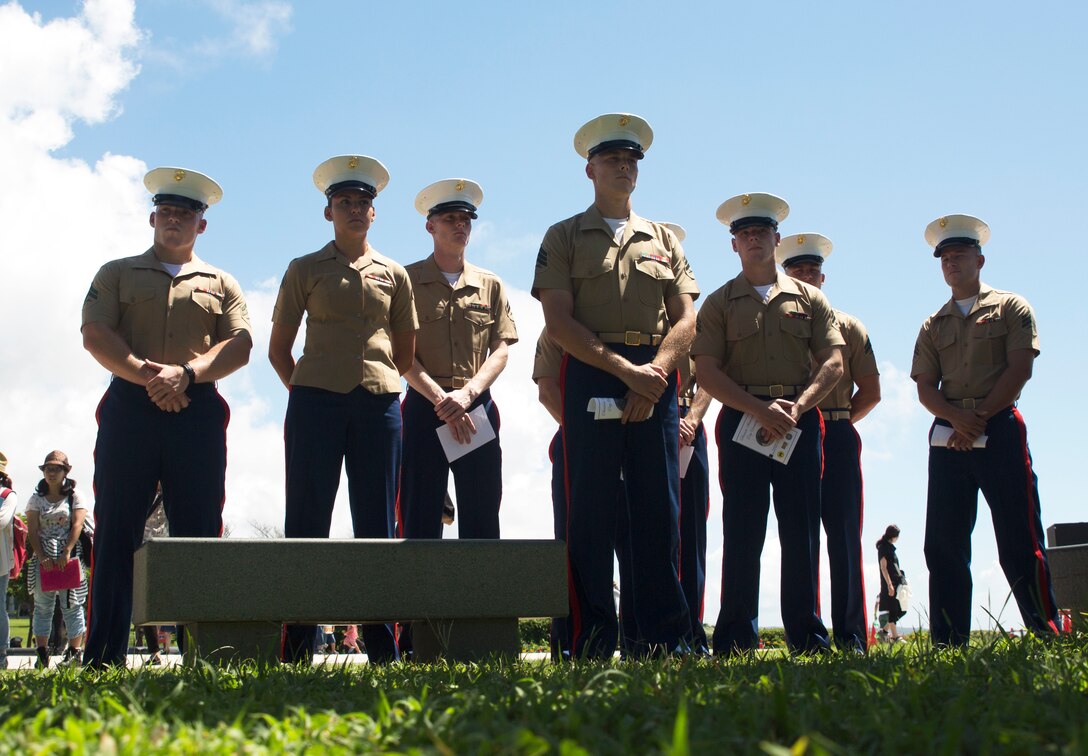 U.S. Marines stand to honor the fallen during the 2016 Okinawa Memorial services June 23 at Peace Memorial Park, Itoman, Japan. The ceremony brought Okinawa residents and Status of Forces Agreement members together to honor those whose lives were lost in the Battle of Okinawa. During the ceremony, distinguished guest speakers gave speeches to honor the fallen in the Battle of Okinawa and laid wreaths at the memorial walls, on which the names of the fallen were engraved. Attendees, in turn, took a moment of silence and paid tribute to the fallen heroes.