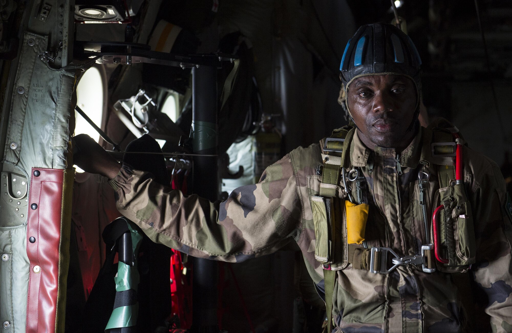 Chief Warrant Officer 2nd Class Lawangu, a jumpmaster with the Gabonese armed forces, assists with directing airdrops for paratroopers from the U.S. Army’s 82nd Airborne Division during exercise Central Accord 2016 in Libreville, Gabon, June 22, 2016. The U.S. Army Africa exercise is an annual, combined, joint military exercise that brings together partner nations to practice and demonstrate proficiency in conducting peacekeeping operations. (DOD photo/Tech. Sgt. Brian Kimball)