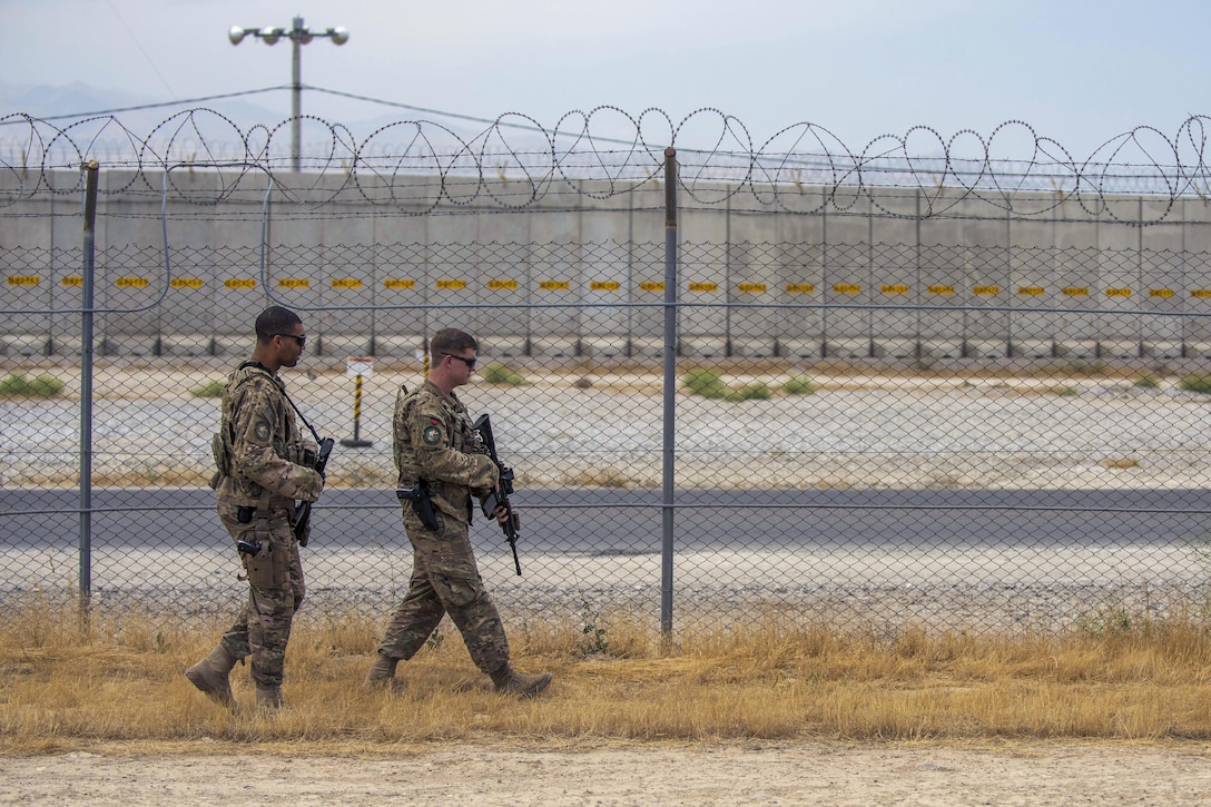 Air Force Staff Sgt. Gary Allsbrook, left, and Senior Airman Michael Van Deusen patrol the flightline perimeter at Bagram Airfield, Afghanistan, June 27, 2016. Allsbrook and Deusen are assigned to the 455th Expeditionary Security Forces Squadron, quick reaction force. Air Force photo by Senior Airman Justyn M. Freeman