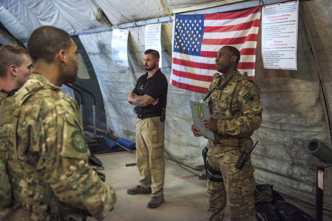 Air Force Staff Sgt. Duranta Gordon gives the guard mount briefing to airmen before patrolling the flightline at Bagram Airfield, Afghanistan, June 27, 2016. Gordon is assigned to the 455th Expeditionary Security Forces Squadron, quick reaction force. Guard mount is conducted at the start of a shift for accountability of weapons and equipment inspections. Air Force photo by Senior Airman Justyn M. Freeman