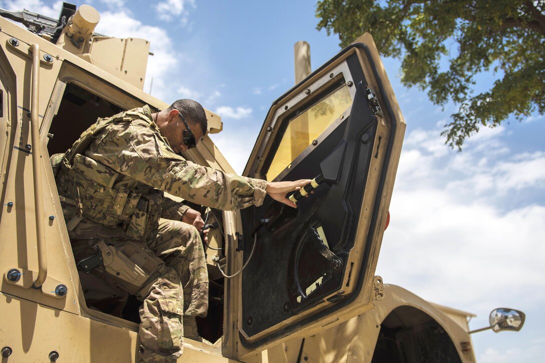 Air Force Staff Sgt. Gary Allsbrook gets into a mine-resistant, ambush-protected vehicle before participating in a security patrol on the flightline at Bagram Airfield, Afghanistan, June 27, 2016. Allsbrook is assigned to the 455th Expeditionary Security Forces Squadron, quick reaction force. Air Force photo by Senior Airman Justyn M. Freeman