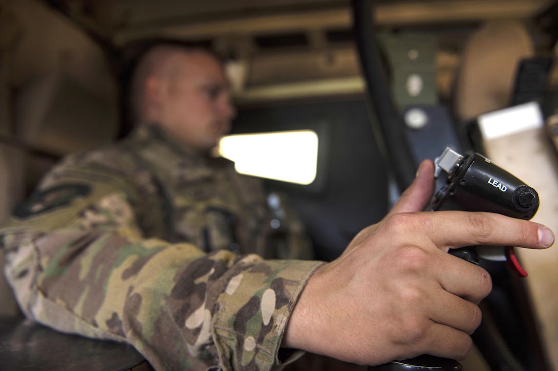 Air Force Senior Airman Jedsen Nunes operates a common remotely operated weapons station inside his mine-resistant, ambush-protected vehicle during a security patrol on the flightline at Bagram Airfield, Afghanistan, June 27, 2016. Nunes is assigned to the 455th Expeditionary Security Forces Squadron, quick reaction force. Air Force photo by Senior Airman Justyn M. Freeman